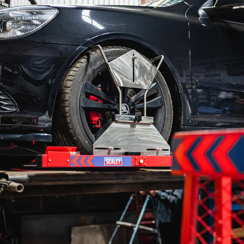 Four wheel laser alignment in progress on a Mercedes